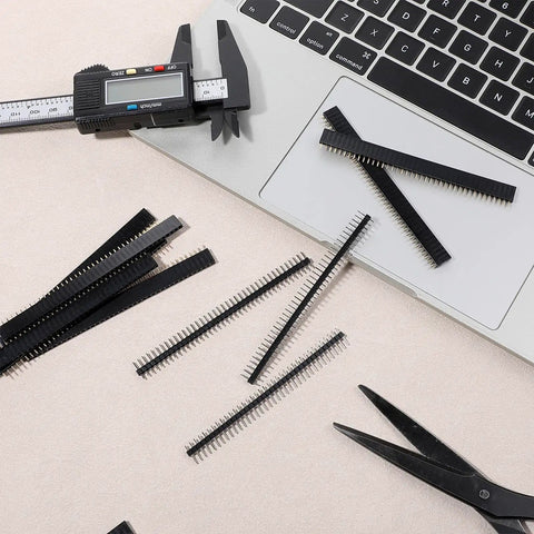 30 Piece 2.54mm 40 Pin Male And Female Header Pins Set on a desk with a laptop and tools for PCB projects