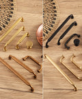 Assorted drawer pulls and knobs, including Antique Brass Zinc Alloy Cabinet Pulls 3 Inch Hole Center 76mm, on a wooden surface.