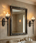 Gatheroad Pillar Candle Wall Sconces Set of 2, Gothic Lattice Crown Decor mounted beside a mirror in a bathroom.