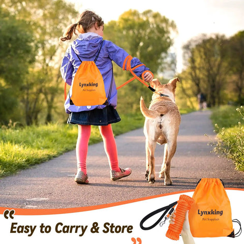 Child walking dog with Heavy Duty Check Cord Dog Leash Long Training Lead, orange bag visible, outdoors, tree-lined path.