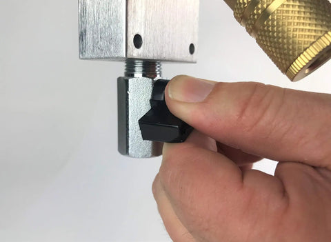 Hand adjusting shutoff valve on Solid 7 Piece Air Line Fitting Kit 1 2 Inch Push To Connect Pneumatic Outlet Block.