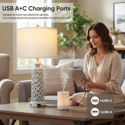 Woman using tablet next to a Two Modern 26 Inch Table Lamp With USB A And USB C Ports, 3 Way Dimmable Touch Control, in living room.