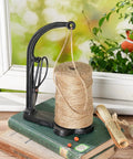 Cast Iron Twine Holder Set With 1300ft Natural Jute Twine on wooden table, includes scissors, antique sewing machine style, black finish