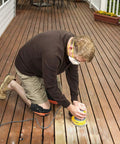 Person kneeling with Heavy Duty Gel Padding Knee Pads With Strong Double Straps For Work, orange color on a wooden deck