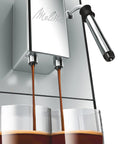 Game Changing Bean To Cup Automatic Coffee Maker With Creamy Frothed Milk and Slick Silver Black Design pouring espresso into glasses.