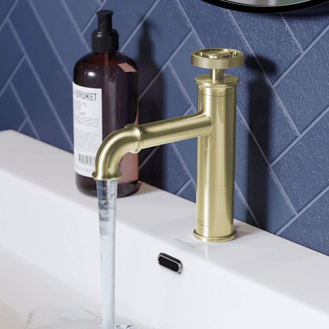 Brushed Gold Single Hole Bathroom Faucet With One Hand Control Solid Brass Durability 1.2 GPM Flow on a white sink