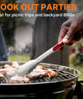 Grilling burgers with tongs from the Camping Cooking Utensils Set 16 Piece Camp Kitchen Kit With Organizer Bag Portable RV Camping Essentials