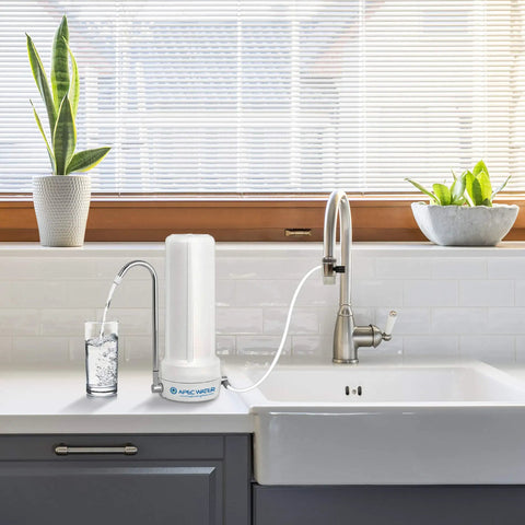 4-In-1 Ceramic Countertop Water Filter System for clean and safe drinking water beside a kitchen sink, ready to use.