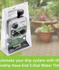 Packaged Analog Three Dial Sprinkler Timer With Rain Delay For Drip Irrigation Garden on display in front of potted plants.