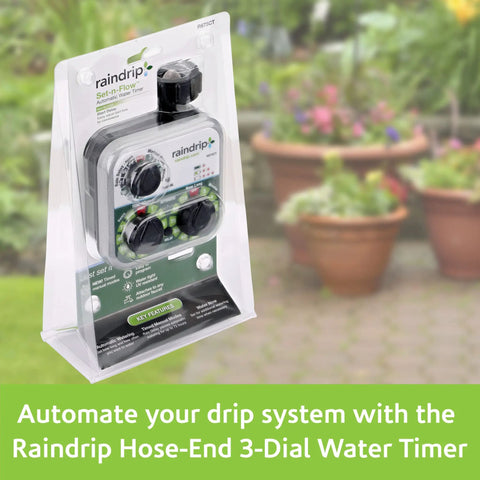 Packaged Analog Three Dial Sprinkler Timer With Rain Delay For Drip Irrigation Garden on display in front of potted plants.