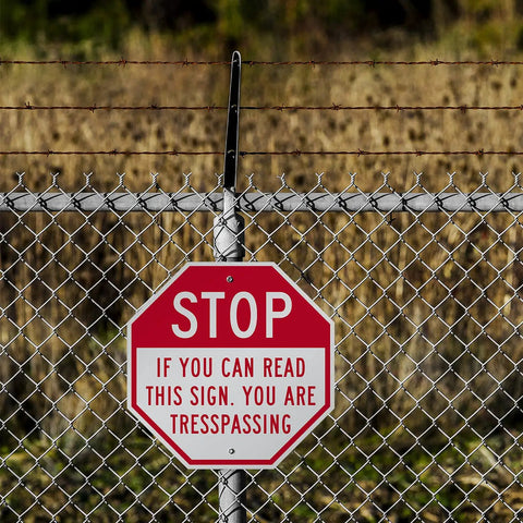 Tough As Nails Custom Stop Sign 18 X 18 Inches With Super Slick 3M Reflective Finish Hella Durable Rustproof Aluminum Metal For Outdoor Parking Lots Gates And Garages Usa Made attached to a chain link fence.