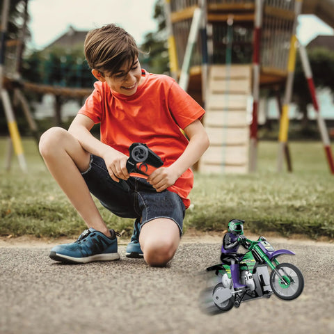 Child playing with Crosslander RC18 Electric Motocross Bike With 2.4 GHz Radio Control Up To 12 Kmph Speed in a park.