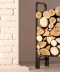 Sturdy Firewood Rack And Log Holder For Indoor Outdoor Use Heavy Duty 25mm Tubular Steel Log Storage Stack Supports Up To 400 Pounds Rustproof Black Powder Coated Firewood Organizer For Fireplace And Patio next to fireplace.