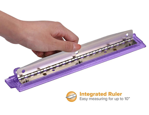 Purple 3 Hole Punch For Ring Binders With Integrated Ruler And Five Sheet Capacity, shown in hand, compact design for easy use.