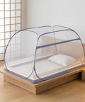 Pop Up Mosquito Tent With Instant Fold Frame For No Hassle Setup Sealed Netting Bottom And Ultra Portable Travel Bag Indoor Outdoor Use For Kids And Adults Ready For Camping In Backyards Beaches And Road Trips set up on a bed indoors