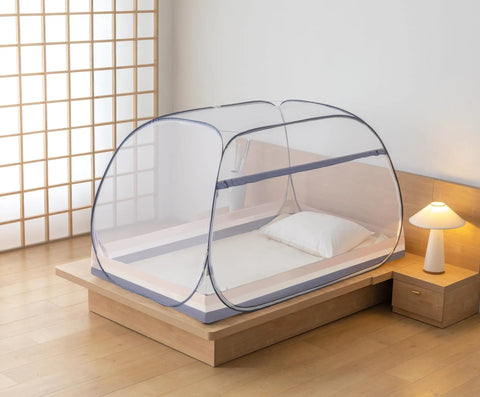 Pop Up Mosquito Tent With Instant Fold Frame For No Hassle Setup Sealed Netting Bottom And Ultra Portable Travel Bag Indoor Outdoor Use For Kids And Adults Ready For Camping In Backyards Beaches And Road Trips set up on a bed indoors
