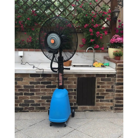 No Sweat Commercial Misting Fan Delivers Beast Mode High Velocity Airflow For Restaurants And Warehouses Featuring Rock Solid Metal Housing And Quick Adjustable Tilt Swivel In Blue, positioned near a flowered wall.