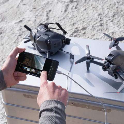 Hands operating smartphone with FPV Drone Bundle With Remote Controller And Goggles Renewed Immersive 150 Degree FOV 4K 60FPS Video setup