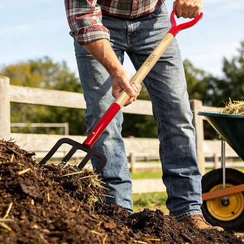 Gardener using 4-Tine Spading Garden Fork With Steel Digging Tines, 45 Inch Length, Y-Grip Wood Handle in compost pile