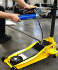 Mechanic using Heavy Duty Pistol Grip Grease Gun Kit 14oz Mini Grease Gun With 6000 PSI Leakproof Seal on industrial equipment