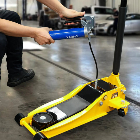 Mechanic using Heavy Duty Pistol Grip Grease Gun Kit 14oz Mini Grease Gun With 6000 PSI Leakproof Seal on industrial equipment