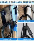 Real Deal Wall Mount EV Charger Holder Built For Everyday Drive Use Compatible With Popular J1772 Type 1 Connectors on wooden, brick, and cement walls.