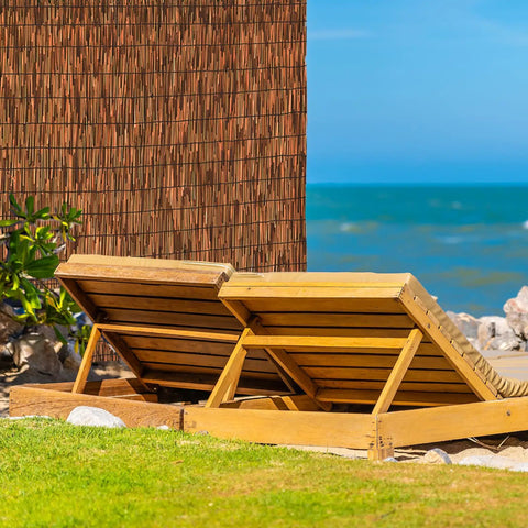 Brown 6 Ft Reed Fencing Roll 16.4 Ft Long Outdoor Privacy Screen beside lounge chairs by the sea