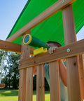Child using toy telescope on cedar wood swing set with wave slide and elevated play deck. Focus keyword: Cedar Wood Swing Set With Wave Slide And Elevated Play Deck, Double Rock Wall, Rope Ladder, Web Swing And Belt Swings, Toy Telescope, Steering Wheel, Sandbox Area For Backyard Adventure And Kid Approved Outdoor Fun.