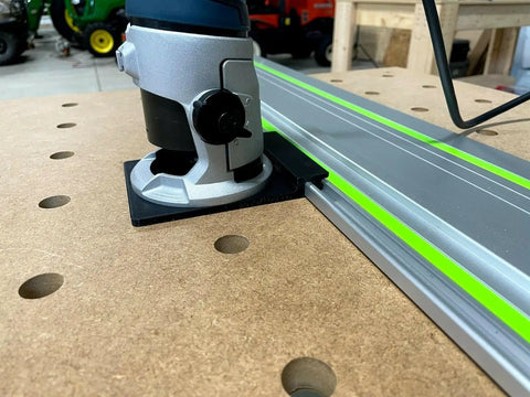 Plug And Play Guide Rail Adapter For Bosch Colt 1.25 HP Router attached to aluminum track on a workbench for precise cuts.