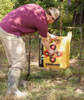 Man adjusting a bag target on a Bag Target Stand for Indoor and Outdoor Archery Practice Durable Adjustable Bag Holder in a forest