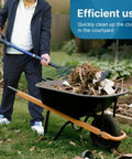 Person using wide 10-tine pitch fork for gardening and farm cleanup, heavy duty manure and mulch fork with fiberglass handle