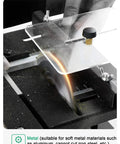 Close-up of Compact Mini Sliding Table Saw Bad Boy Electric Bench Saw cutting acrylic with adjustable guard.