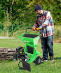 Man operating 3 In 1 Wood Chipper Shredder Mulcher MF30 Heavy Duty Gas Powered 7HP 212cc with 3 inch capacity outdoors
