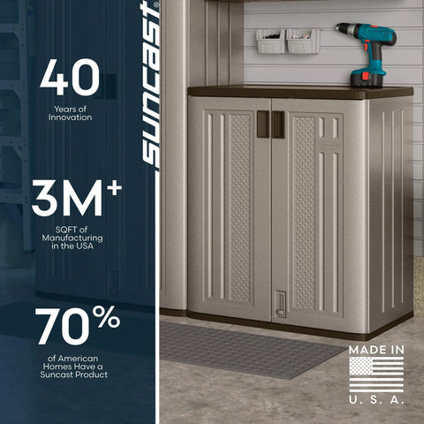 36-Inch Resin Base Garage Storage Cabinet In Platinum, Garage-Ready Build With Double Wall Construction, Rust And Dent Resistant, Corner Friendly Fit, Stashes Tools, Toys, And Gear, Made In The USA placed in a garage corner with a drill on top.
