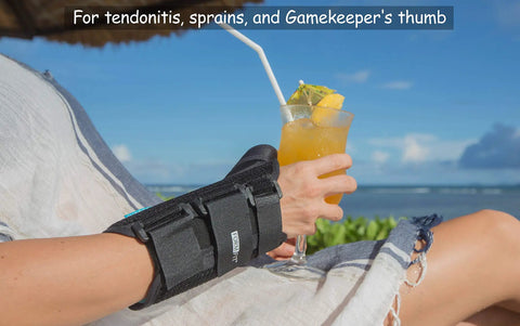 Right hand wearing Thumb Spica Arthritis Support For Gamekeeper’s Thumb And Tendonitis, sipping drink by beach.