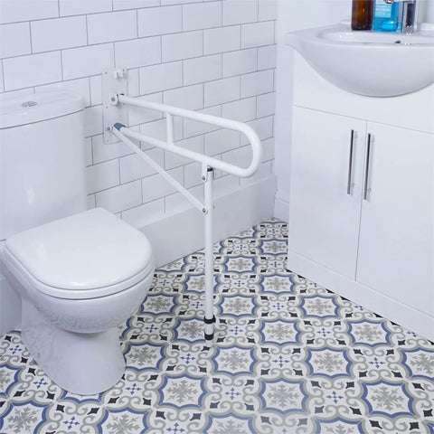 Heavy Duty Stainless Steel Toilet Safety Rails Featuring A Foolproof Flip Up Mechanism With Sturdy Leg Support For Secure Bathroom Access And Comfortable Shower Assistance mounted next to a white toilet.