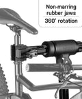 Lift-Assisted Foldable Bike Repair Stand for E-Bikes with foot pedal hydraulic lift, rotating clamp head, non-marring rubber jaws.