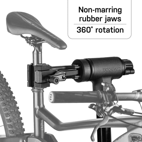 Lift-Assisted Foldable Bike Repair Stand for E-Bikes with foot pedal hydraulic lift, rotating clamp head, non-marring rubber jaws.