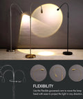Boss Adjustable LED Floor Lamp With Dimmable Zoomable Spotlight Flexible Gooseneck For Reading And Crafting At Home Office From Wide To Focused Beam Antique Brass Finish shown illuminating a surface.