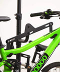 Close-up of Freestanding Four Bike Storage Rack With Adjustable Gravity Hanger holding a green mountain bike securely