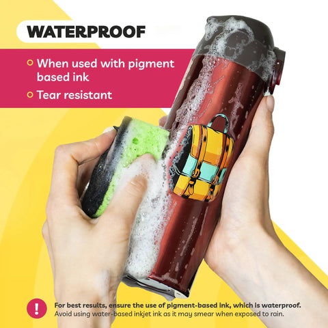 Hands cleaning a red bottle with backpack sticker using Ultra Clear Sticker Paper For Inkjet Printers 20 Sheets Transparent Glossy Printable Vinyl 8.5 By 11 Easy To Peel Strong Adhesive Backing For Bold Photos And Labels Smudge Free Durable DIY Friendly.