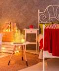 Bedroom scene with a red bedspread, armchair, and side table, featuring 5.9 Inch Wooden LED Light Base Kit Dimmable Colorful Display.
