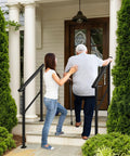 Image of a woman assisting a senior man up steps using Built Tough Outdoor Step Handrails For Seniors, Rock Solid Stair Railing Kit.