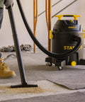 10 Gallon Wet Dry Shop Vacuum With 6 Peak HP Motor And Built In Drain used on workshop floor, emphasizing heavy duty suction.