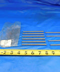 Rock Solid Taper Pins Pack Of Ten Size Five Diameter Four Inch Overall Length Heavy Steel with measuring tape on blue surface.