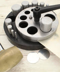 Pro Grade Heavy Duty Steel Circle Disc Cutter Set with ten punches and die cuts, rubber base, and handle, shown with metal discs