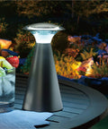 Lanterna Touch Bronze LED Lanterns 2 Pack on outdoor table with drinks, one lantern lit for patio lighting.