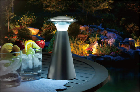Lanterna Touch Bronze LED Lanterns 2 Pack on outdoor table with drinks, one lantern lit for patio lighting.