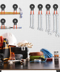 Heavy Duty Magnetic Garage Hooks 4 Pack With Grip Firm Neodymium Magnets mounted on pegboard holding wrenches and tools.