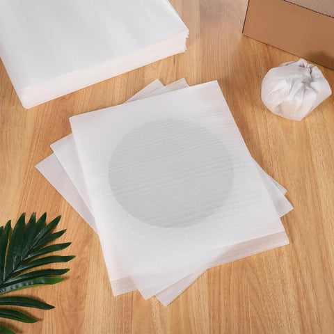 Reusable Foam Pouches And Cushion Foam Sheets White 100 Pack for packing fragile items on wooden surface